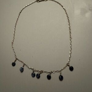 Sterling silver necklace with navy stones hanging down